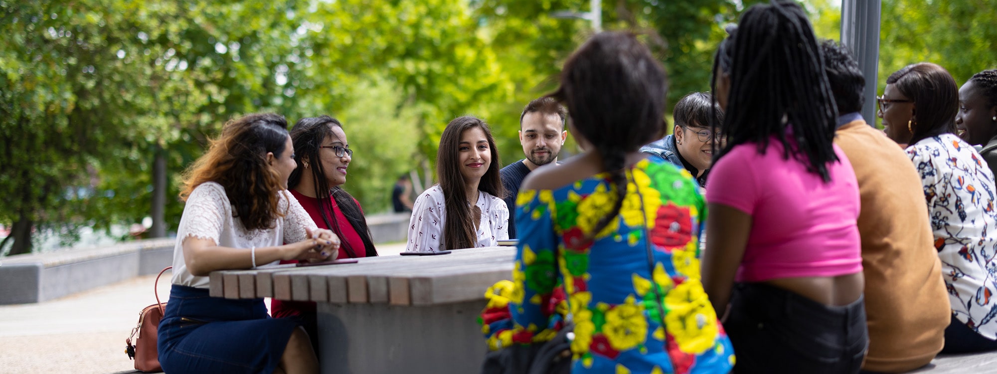 Students chatting at a table outside