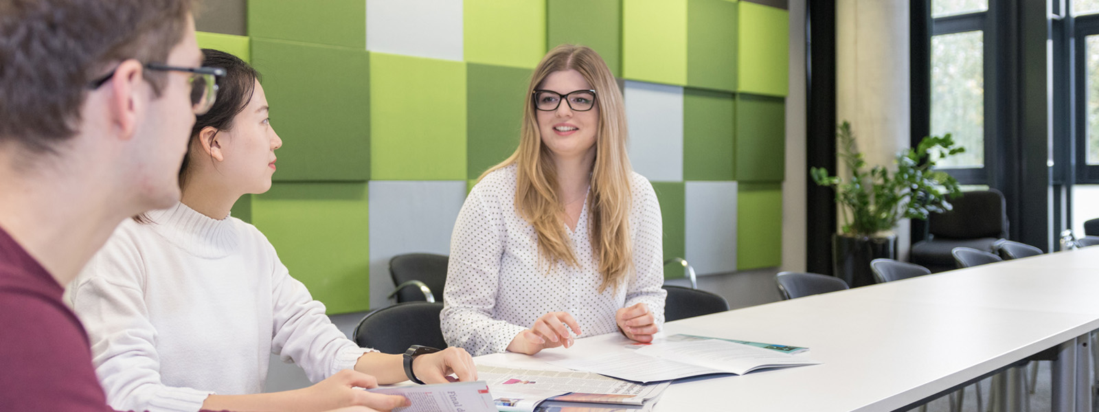 Group of students talking in a seminar room