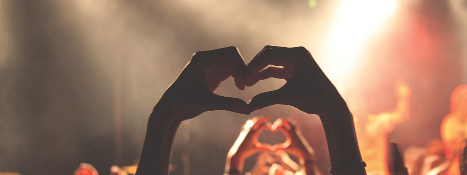 Hands making a heart at event