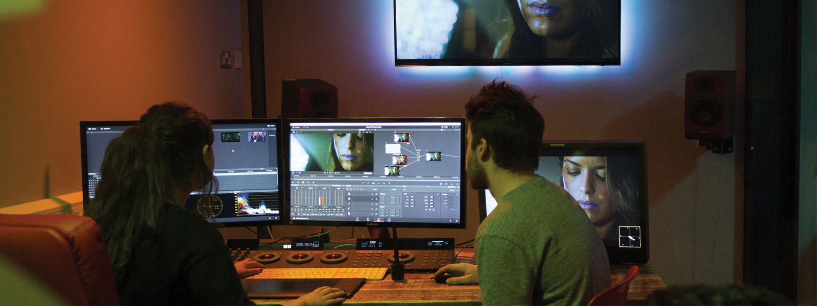 Male student and female student editing a film in The Parlour