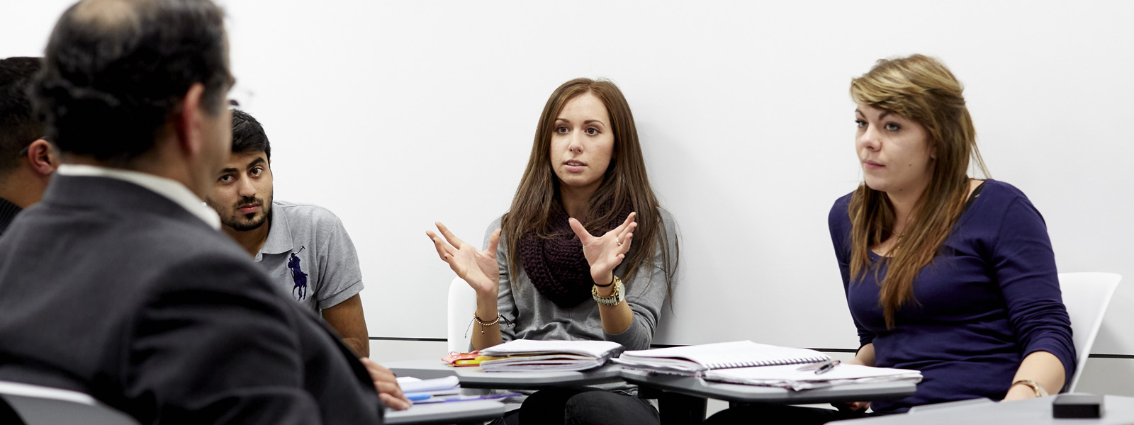 Female student leading a discussion in a classroom