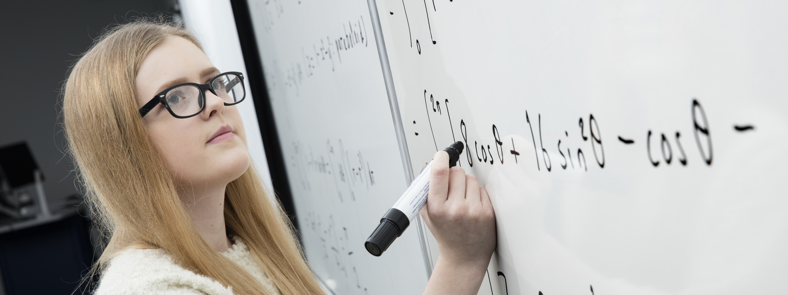 Student writing on a whiteboard