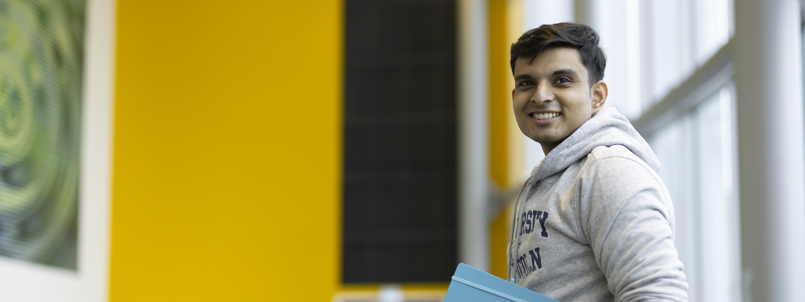 A student holding a notepad