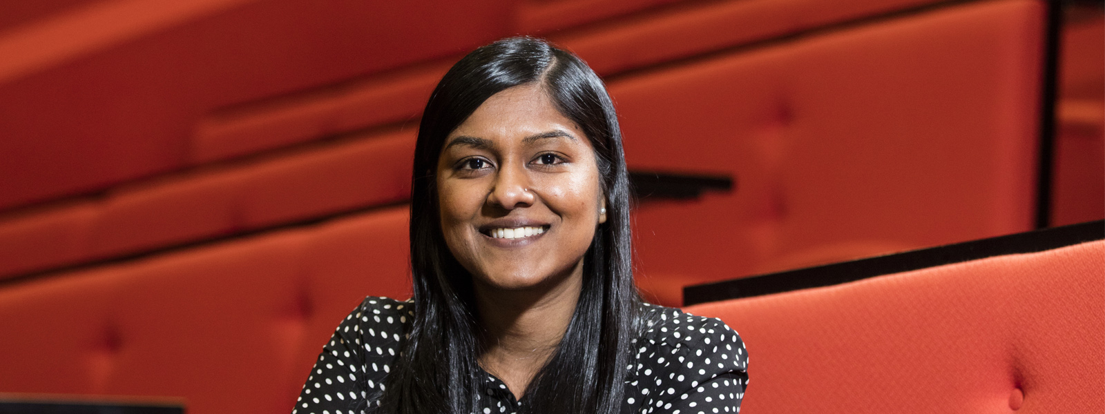 Female student sitting in a lecture theatre