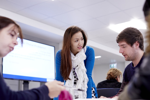 A group of students working together in a seminar room