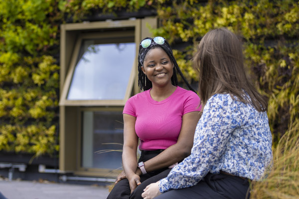 Two students chatting outside the medical school building