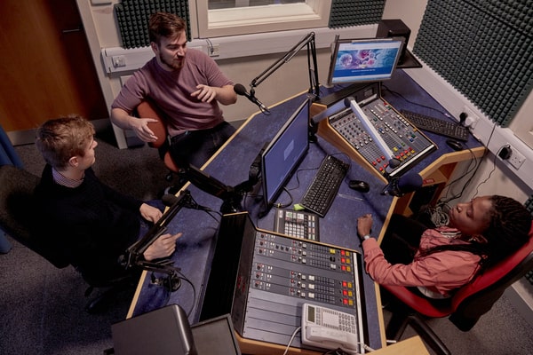 Students taking part in a radio show on campus
