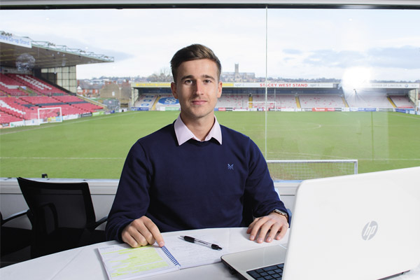 A student working at Lincoln City Football ground