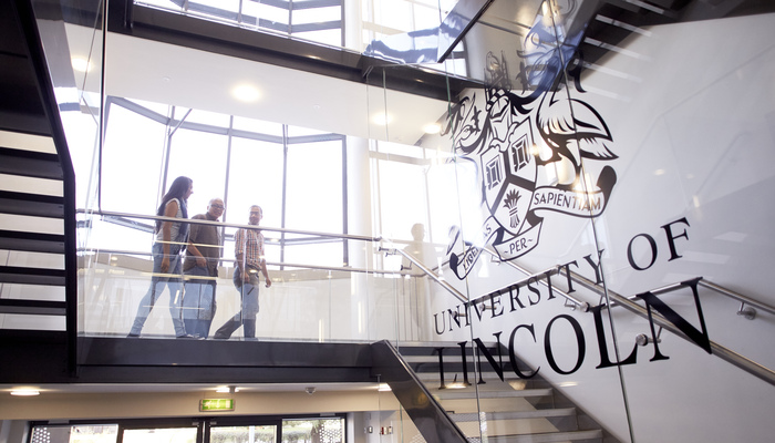 Staff walking down stairs in the Joseph Banks Laboratories