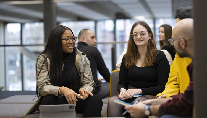 Students chatting while sitting on sofas