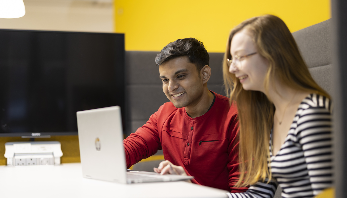 Two students using a laptop