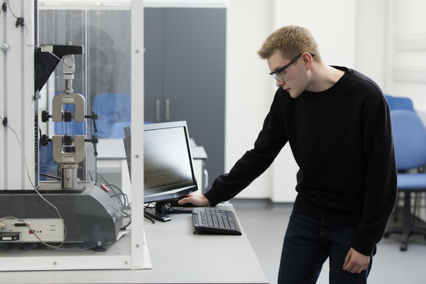 A student monitoring a computer screen