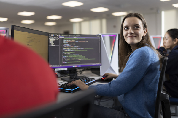 A student working on code at their computer