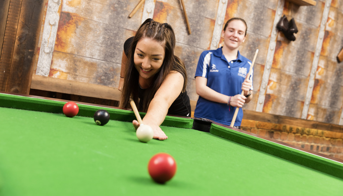 Two students playing pool