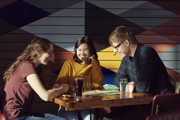 Friends chatting at a table in the Students' Union