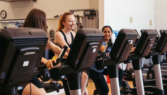 Students using cycling machines in the gym