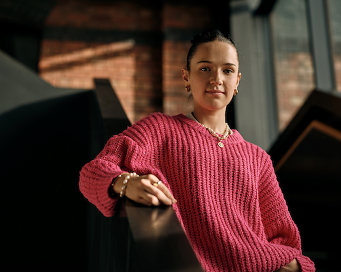 A student wearing a pink jumper