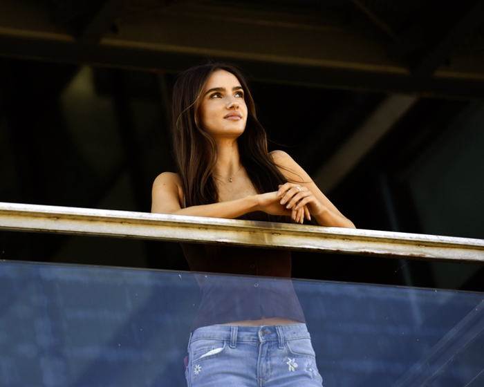A student leaning against a balcony railing