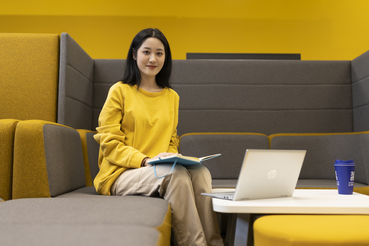 A student working in a shared learning space on campus