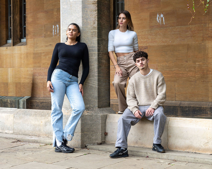 Students posing by a pillar