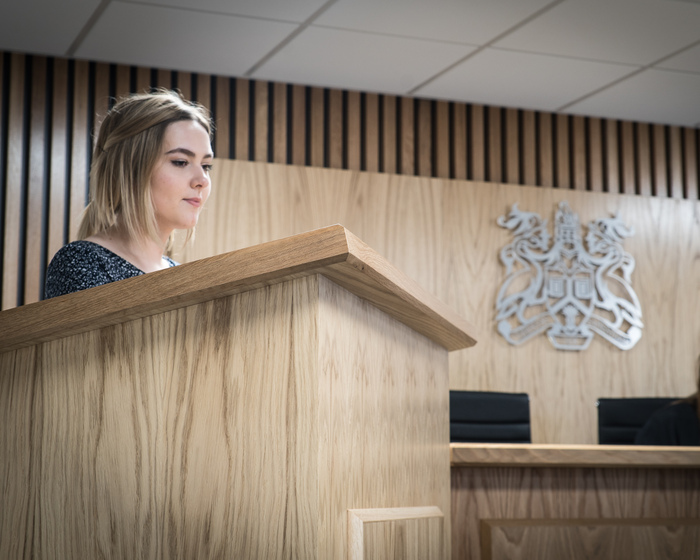 A student practising in the Moot Court