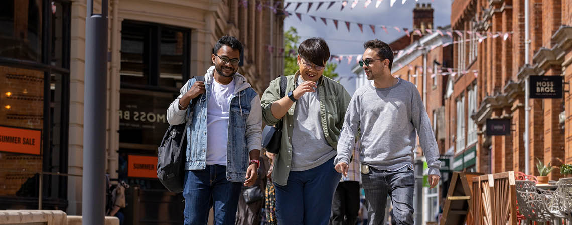 3 male students walking in town