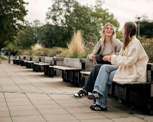 Two student sitting outside Minerva Building