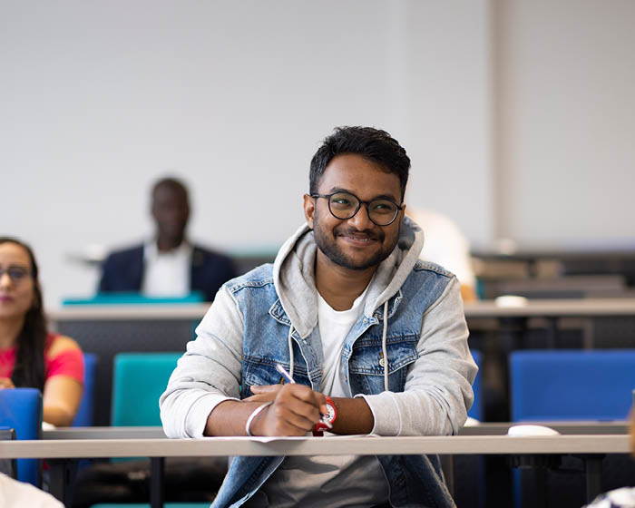 A male student in a lecture theatre