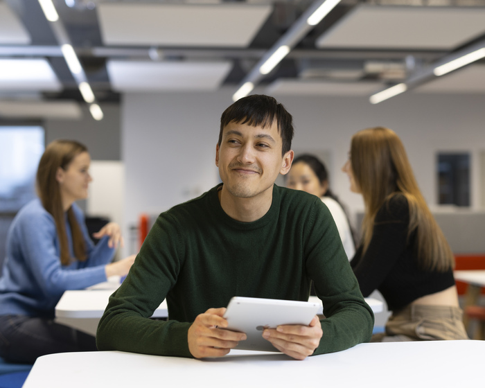 A student holding a tablet