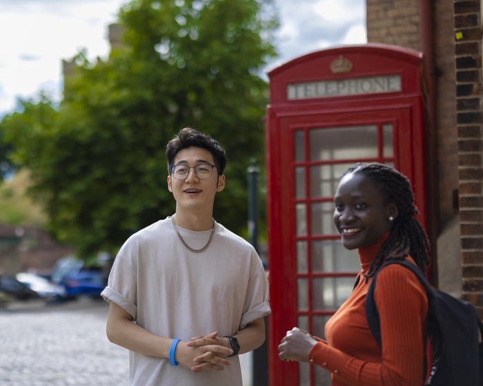 Students stood next to a telephone box