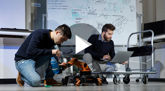 2 students working with robots