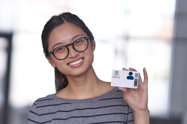 Student holding up their ID card