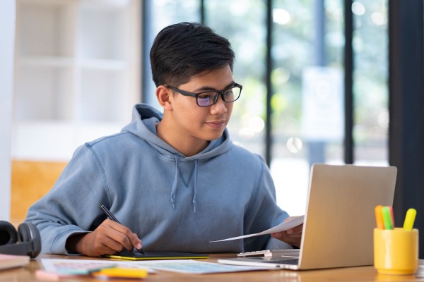 A student looks at a laptop