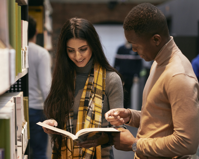 Students reading a book in the library