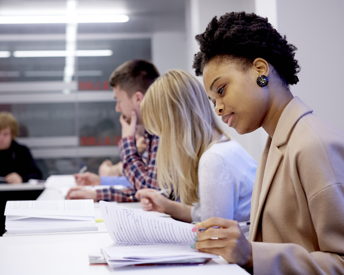 Students looking at notes at desk