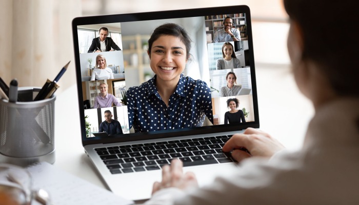 Over the shoulder of a video conference on a laptop.