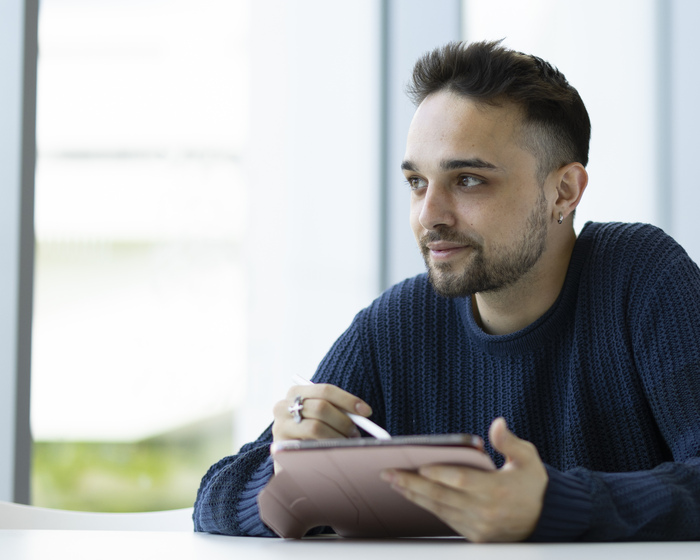 A student looks up from his tablet