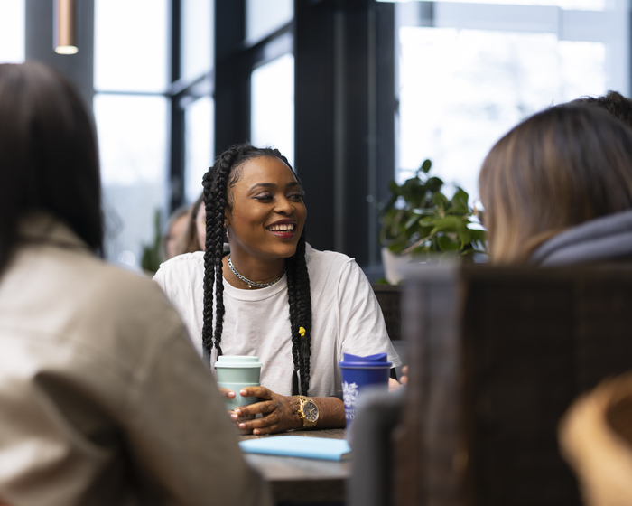 Students sit in a café enjoying a chat