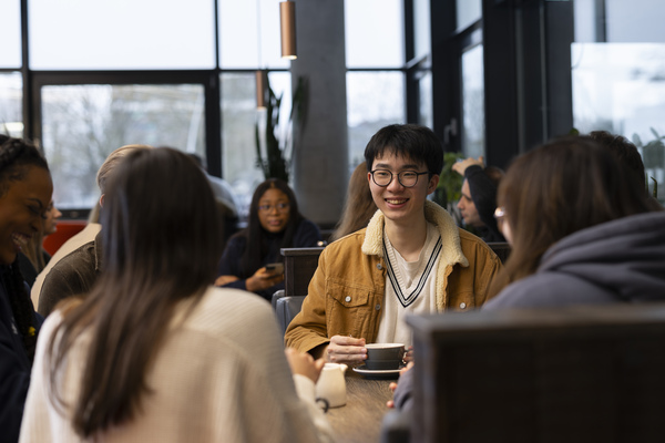 A group of students enjoy coffee at the Pier cafe