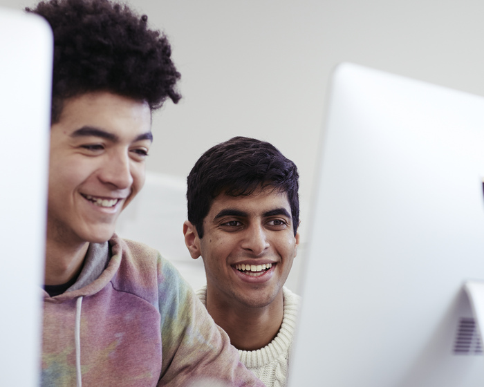 Two students looking at a computer screen