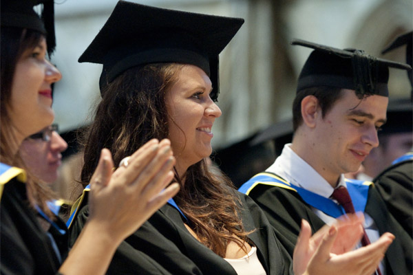 Students clapping at a graduation ceremony