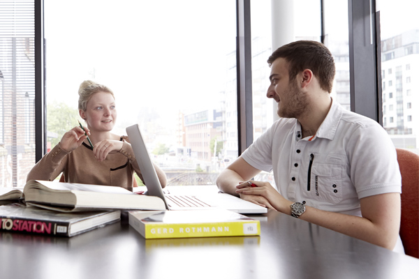 Two people in conversation across a table