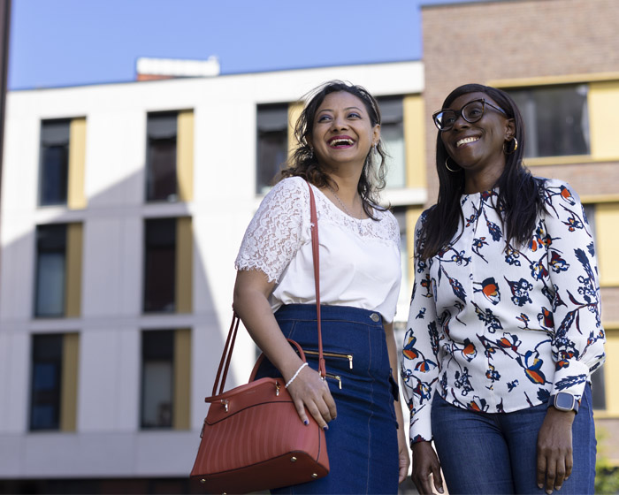 Two members of staff on campus