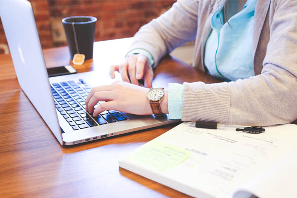 A member of staff working on a laptop