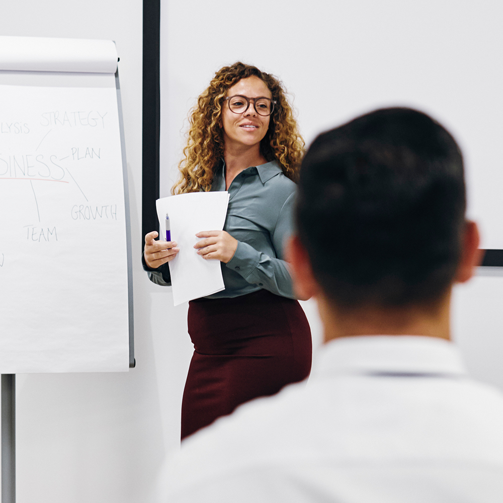 Executive woman leading a session with a flip chart