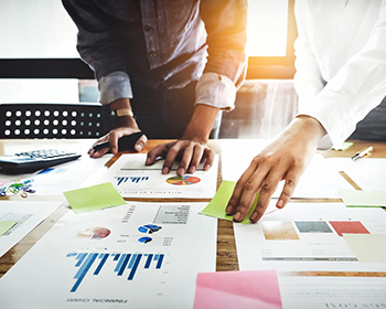 People collaborating over documents on a table