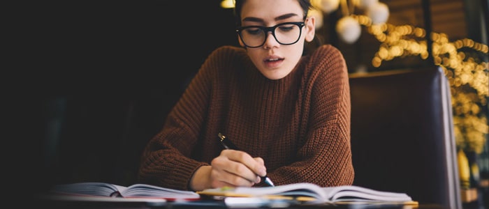 girl studying sat at a table