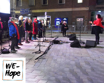 Choir group singing outside in the Cornhill area of Lincoln at night