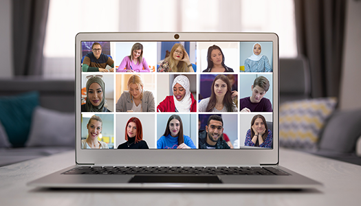 A showcase of peoples headshots displayed on an open laptop computer