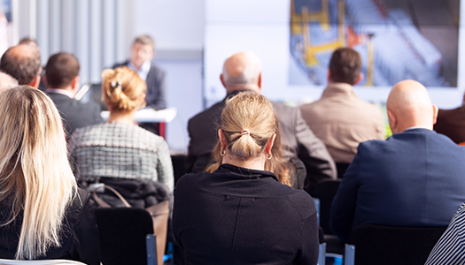 A group of smartly dressed people sat in a meeting